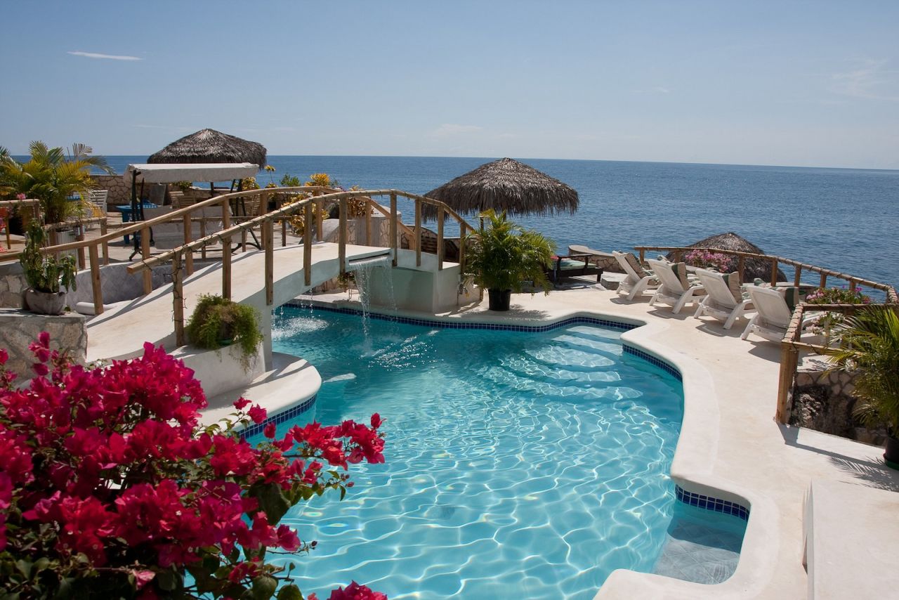 blue pool overlooking the ocean
